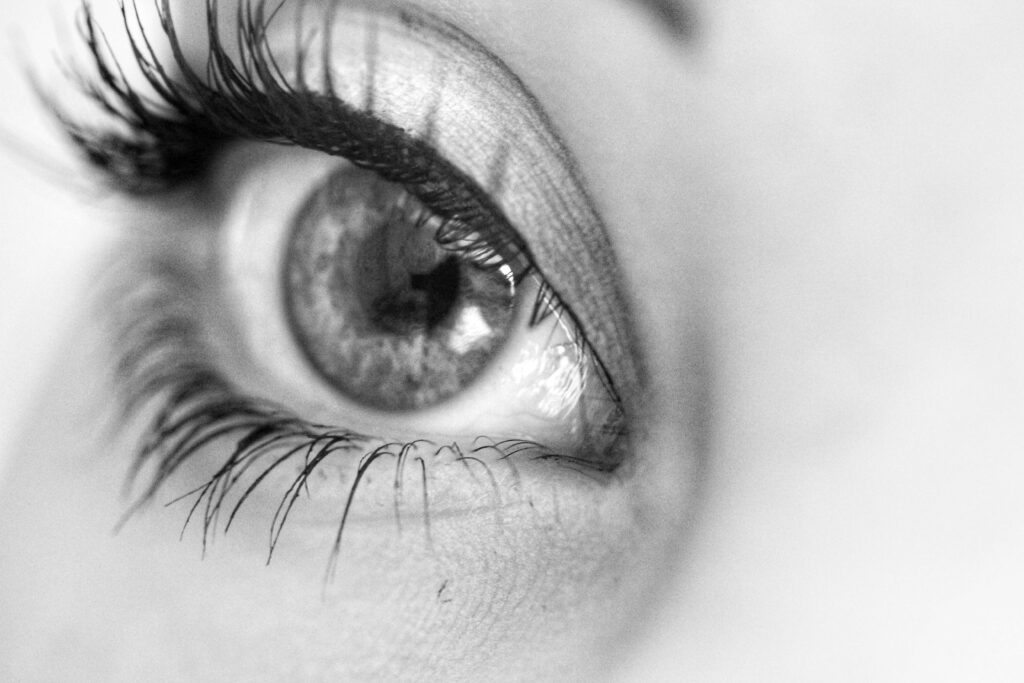 A captivating close-up photo of a human eye in black and white, highlighting intricate details.
